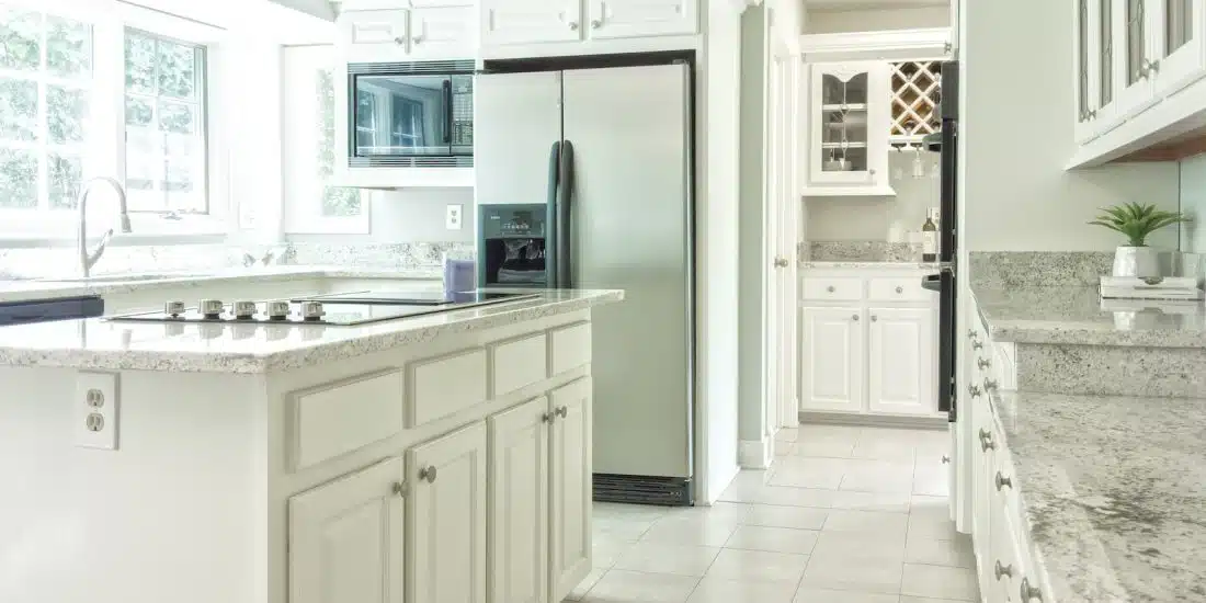 white wooden kitchen cabinet near white wooden door